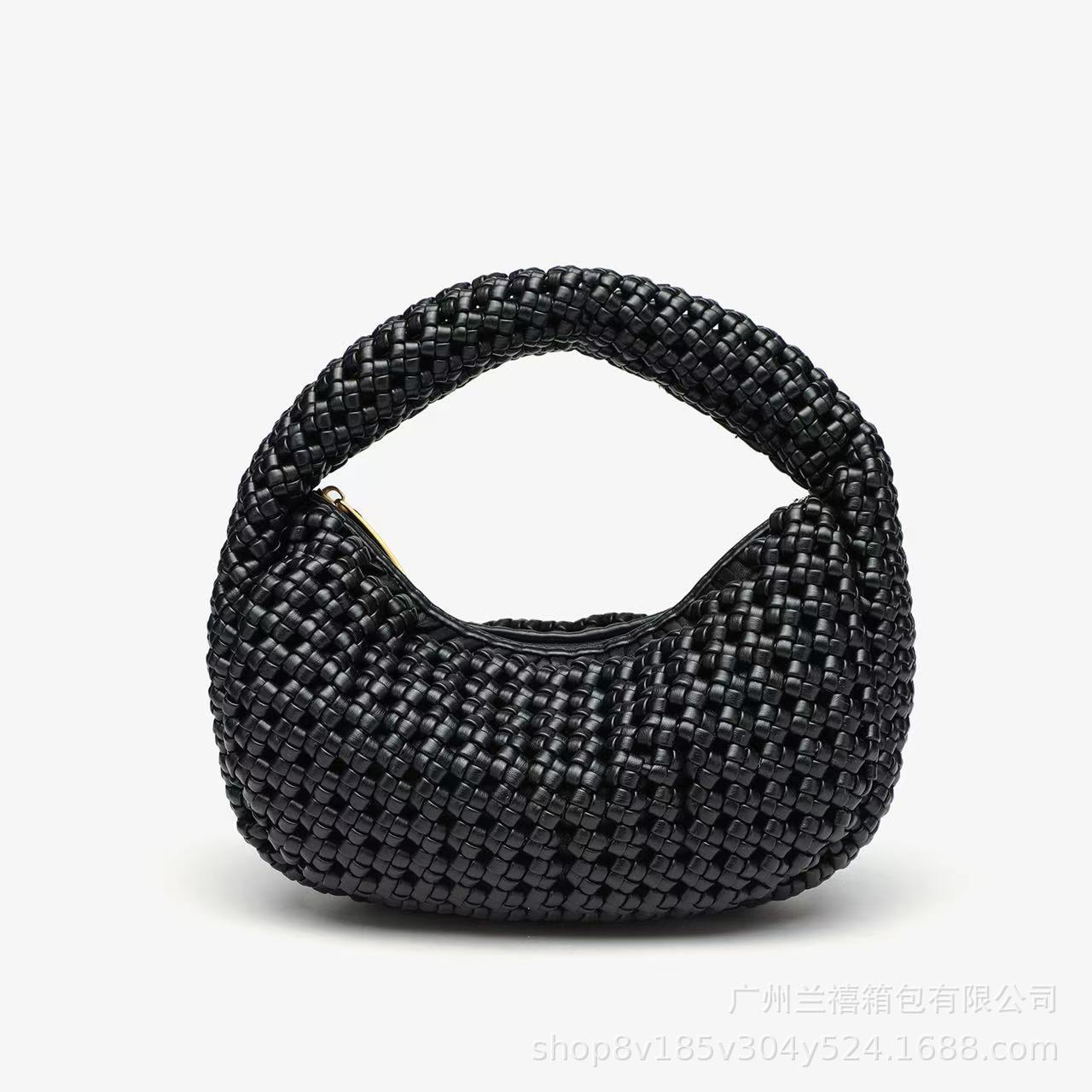 Black woven handbag on a white background