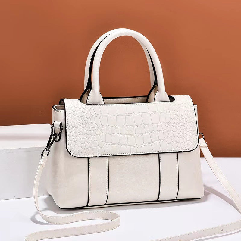 White handbag with a brown background
