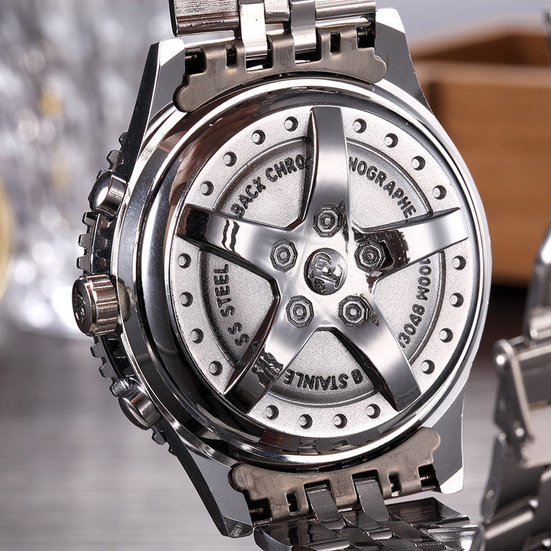 Close-up of a silver watch with detailed mechanical components on a blurred background