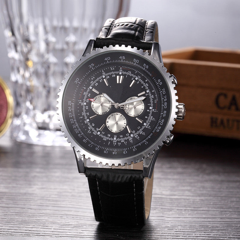 Black wristwatch with detailed face on a wooden surface