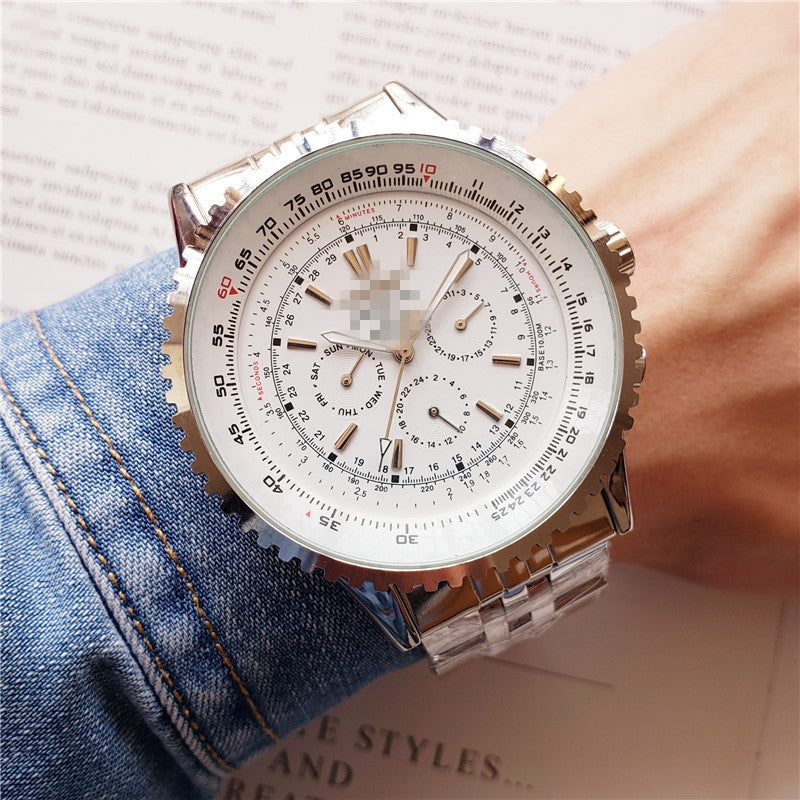 Close-up of a person wearing a detailed wristwatch with a denim sleeve.