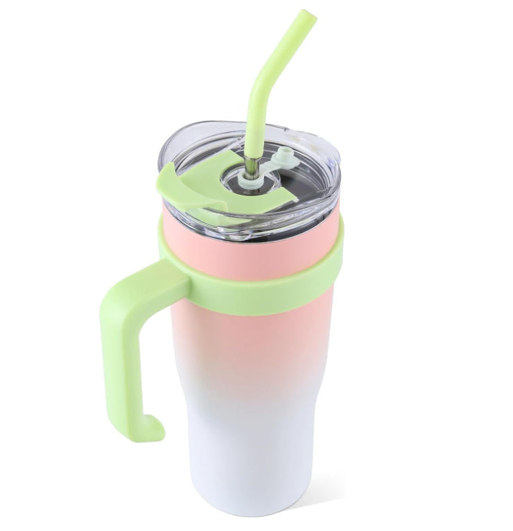 Gradient pink to white tumbler with a green handle and straw on a white background