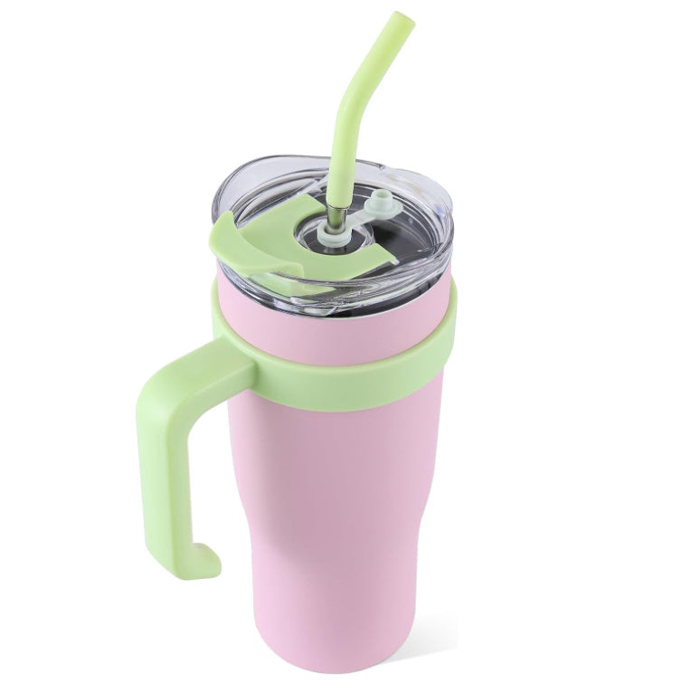 Pink tumbler with green handle and straw on a white background