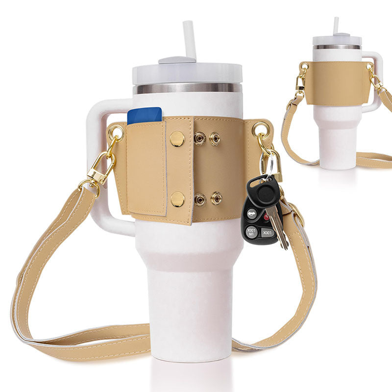 White tumbler with beige holder, keychain, and strap on a white background