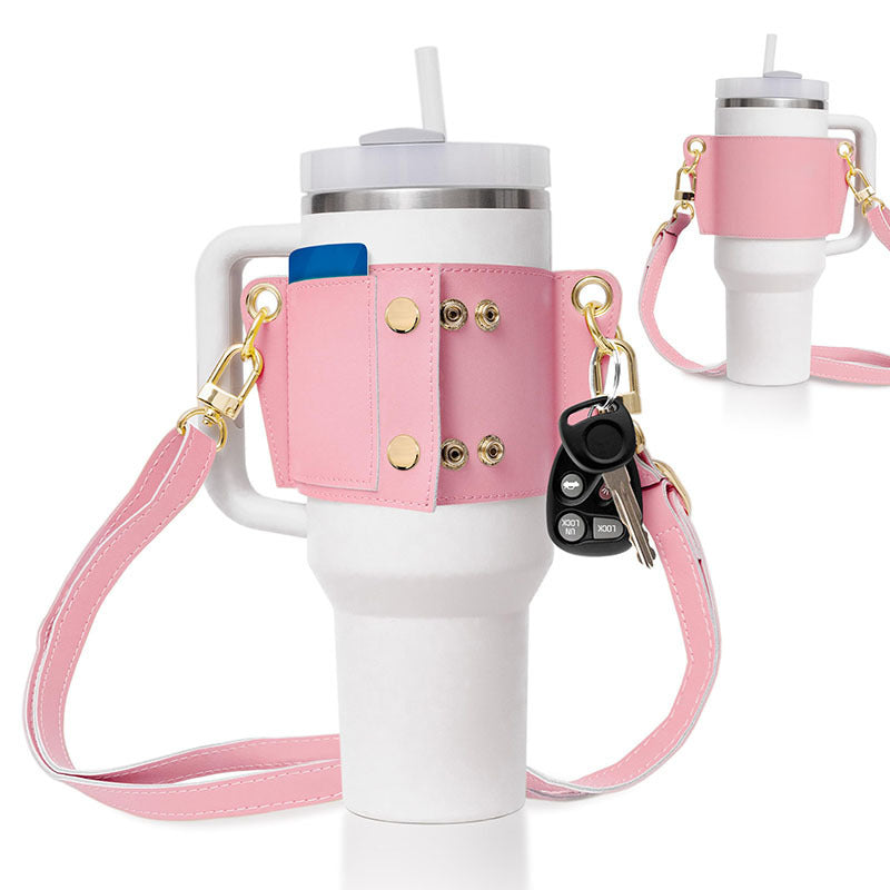 White tumbler with pink holder, keychain, and strap on a white background