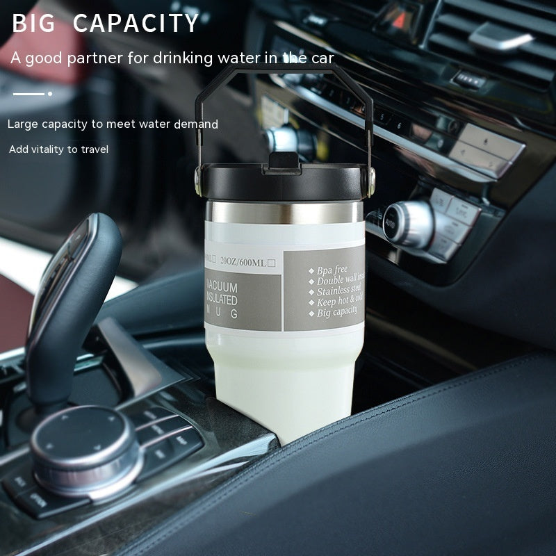 Vacuum insulated travel mug on a car dashboard with text about its capacity and benefits.