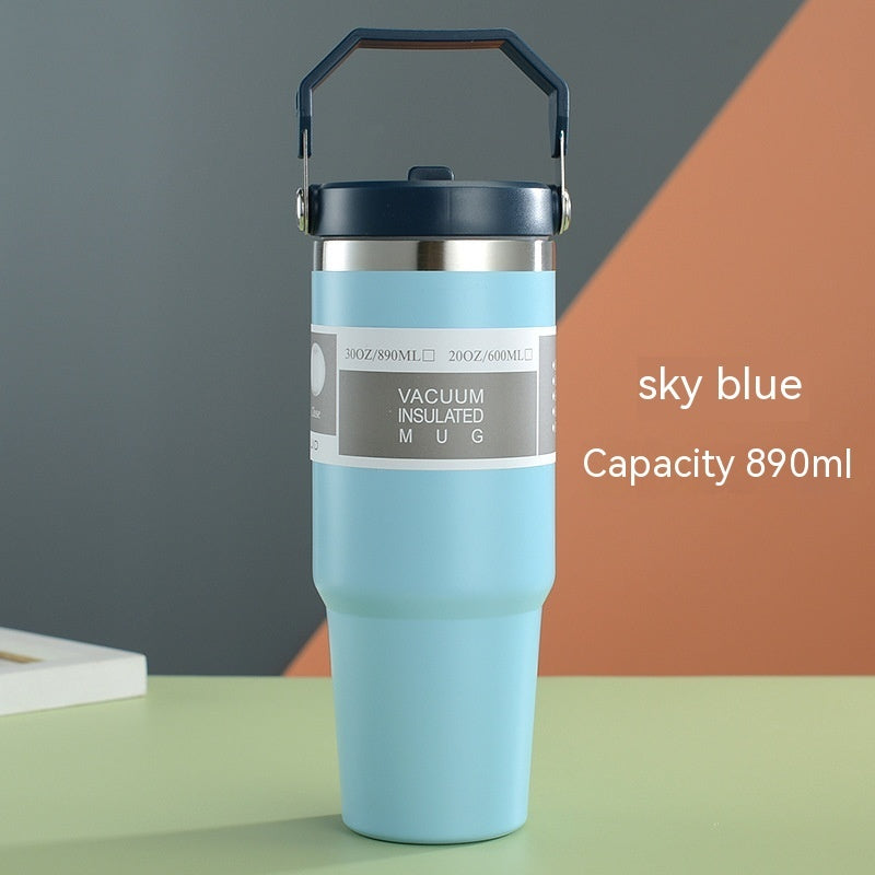 Vacuum insulated mug with handle on a colorful background