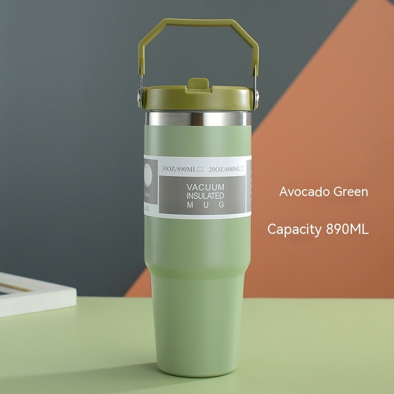 Avocado green vacuum insulated mug on a colorful geometric background