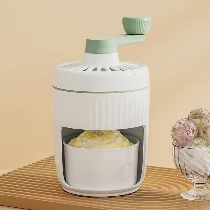 White and green kitchen juicer on a beige surface with decorative elements.