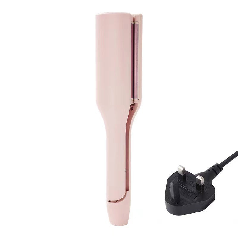 Rose gold hair straightener with plug on a white background