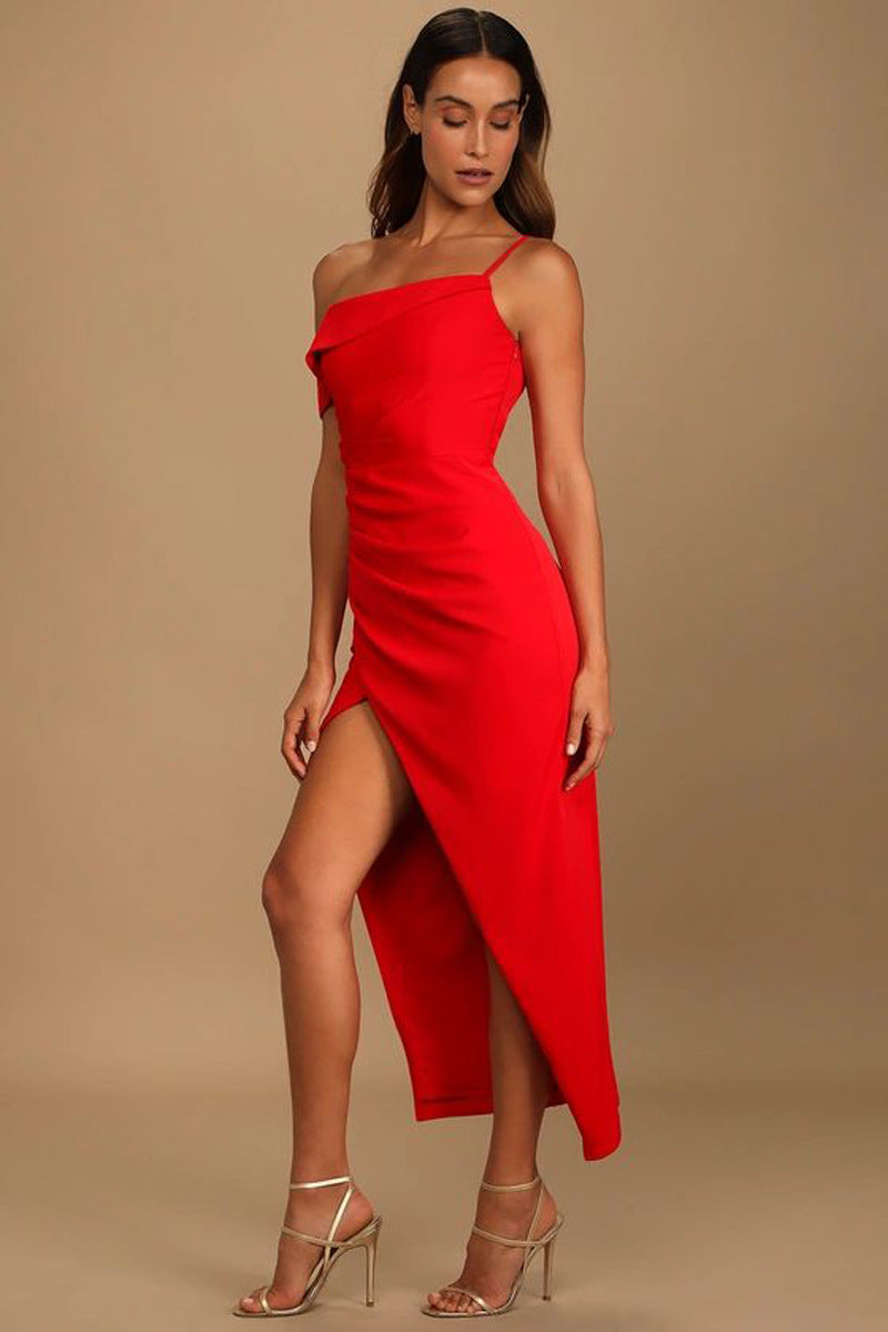 Woman wearing a red one-shoulder dress with a slit on a beige background