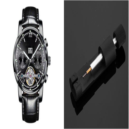 Black wristwatch with detailed face and black leather strap on a dark background