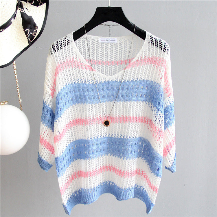 Striped crochet top on a hanger against a gray background