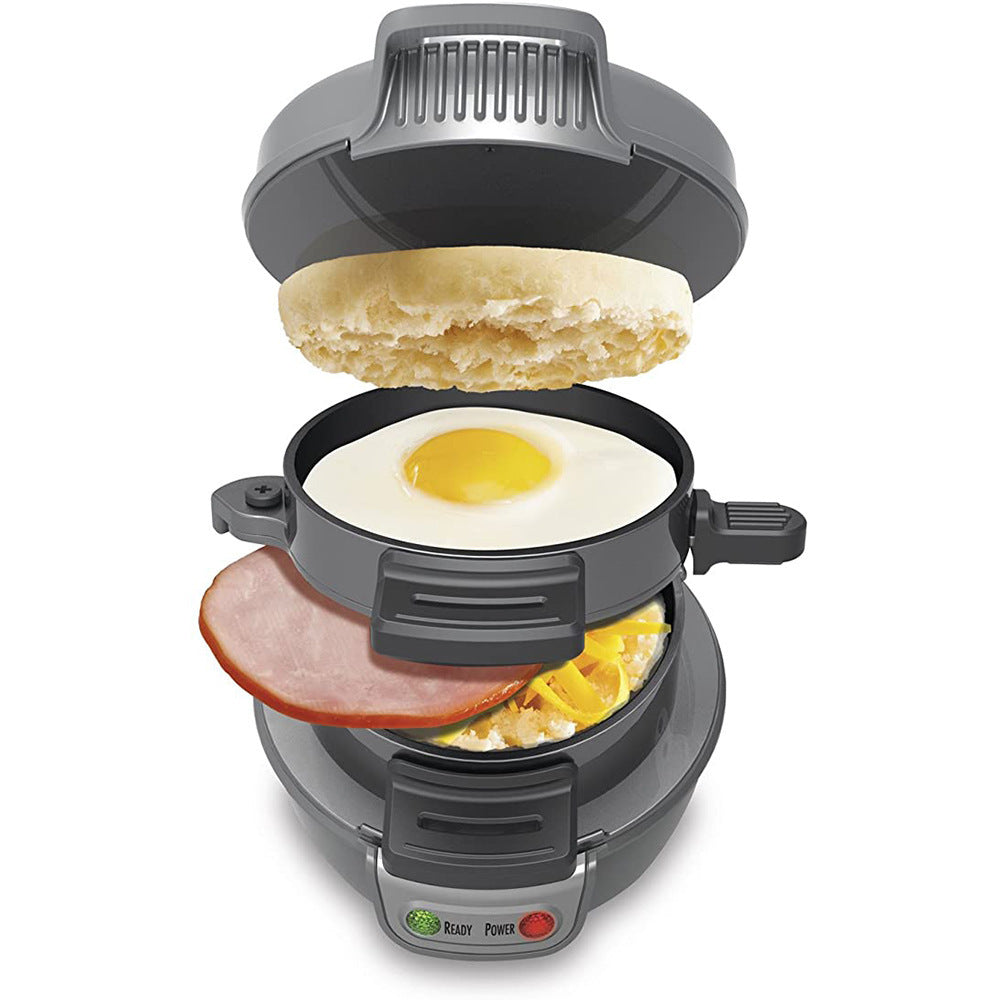 Multifunctional breakfast maker with an English muffin, egg, and ham inside on a white background