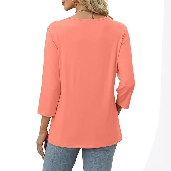 Coral long-sleeve top worn by a person on a white background