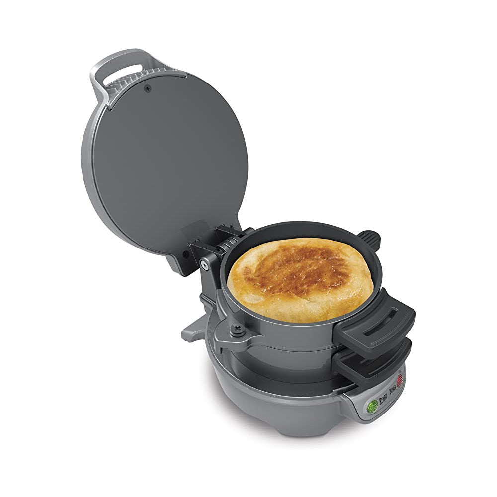Gray waffle maker with a cooked waffle inside on a white background