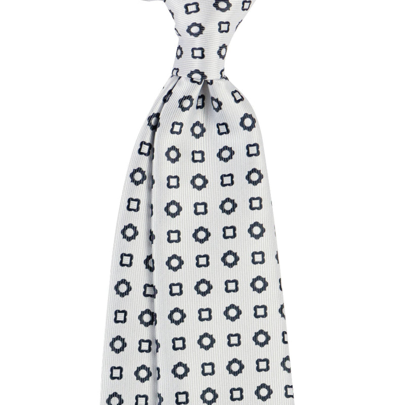 White tie with black geometric pattern on a white background