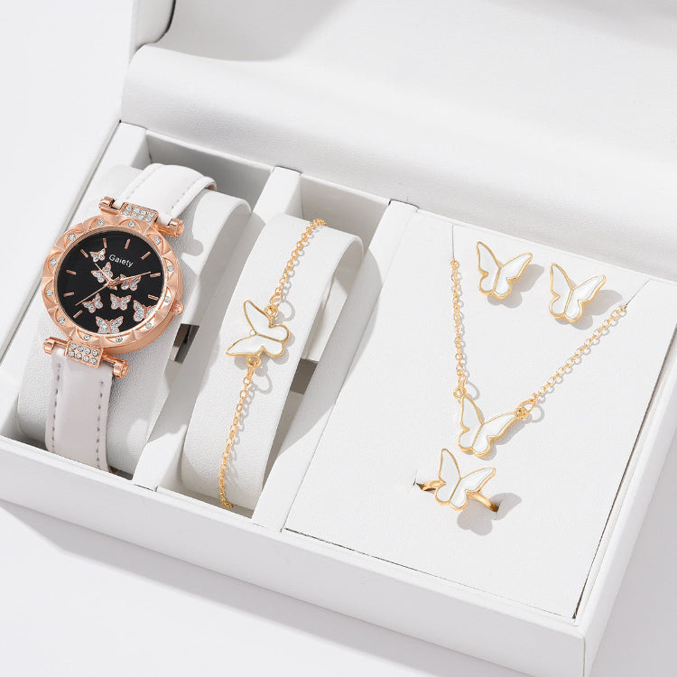 Jewelry set with watch, bracelet, and necklace featuring butterfly designs in a white box.