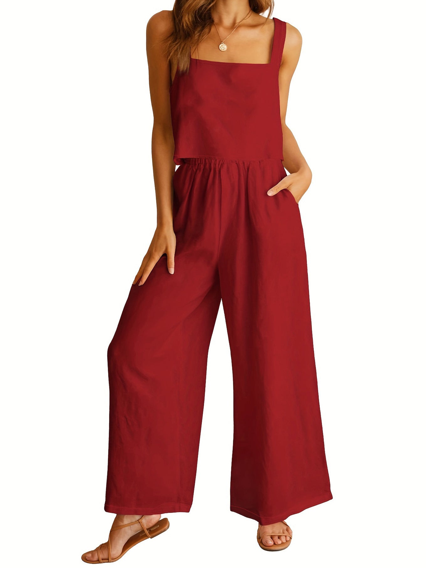 Red jumpsuit worn by a model on a white background