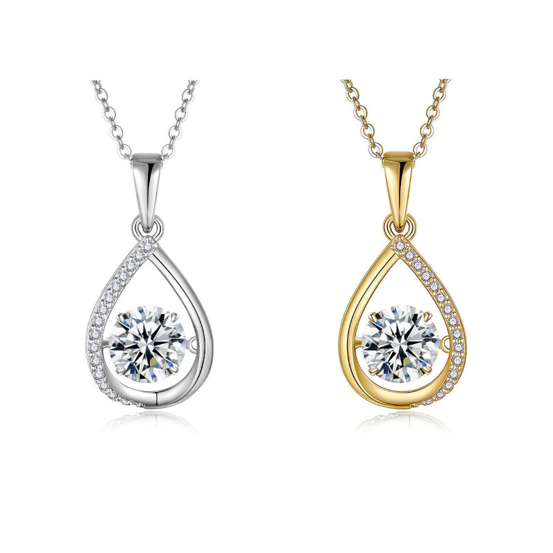 Two teardrop-shaped pendants, one gold and one silver, on white background