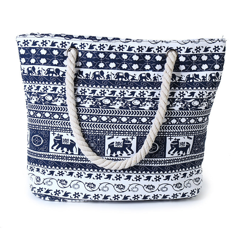 Navy blue and white patterned tote bag with rope handles on a white background