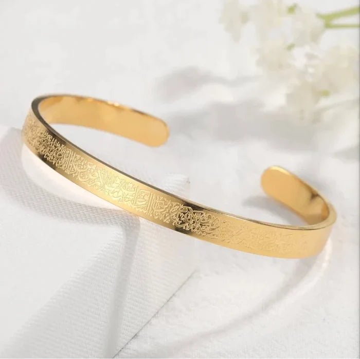 Gold-tone wide cuff bangle with engraved Islamic script, open oval shape
