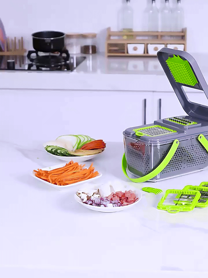 Vegetable chopper and slicer with container, green handle and perforated grater blade.