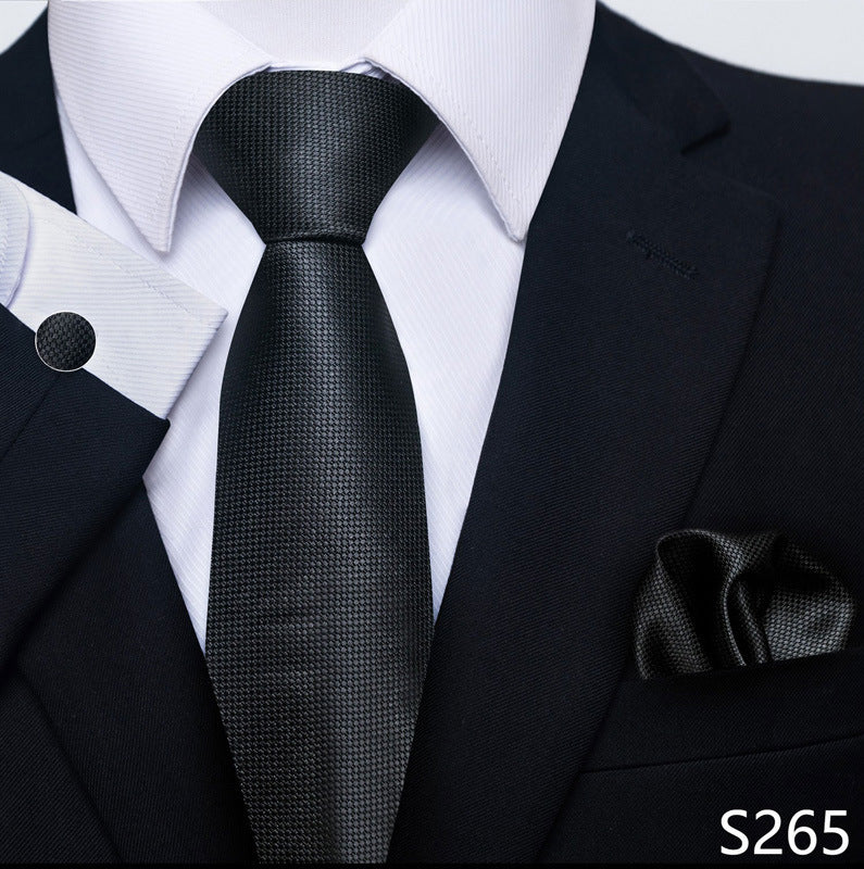 Black textured tie with matching pocket square on a suit, brand 'S265' visible.