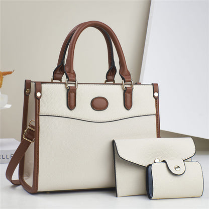 Three-piece shoulder bag set in off-white with brown trim: structured tote plus two pouches
