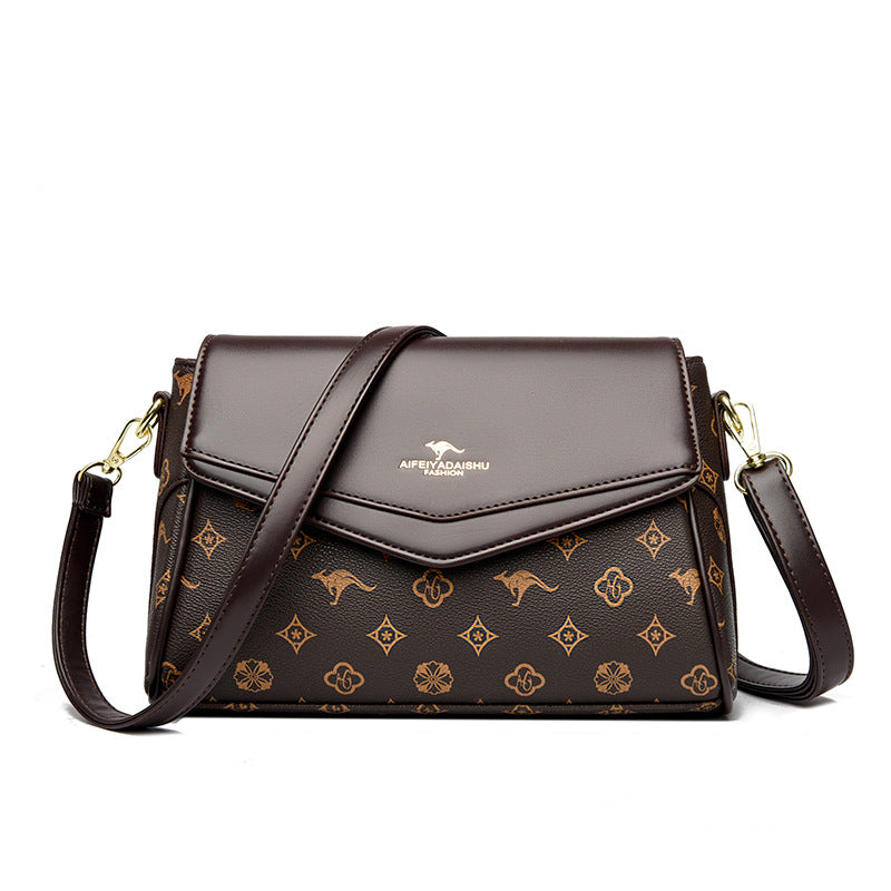 Brown handbag with a patterned design on a white background