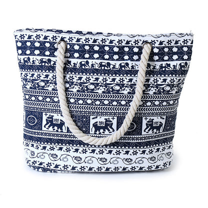 Navy blue and white patterned tote bag with rope handles on a white background