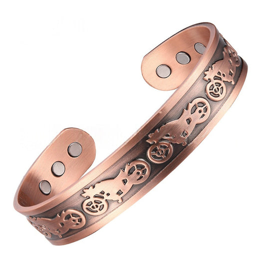 Copper bracelet with engraved designs on a white background
