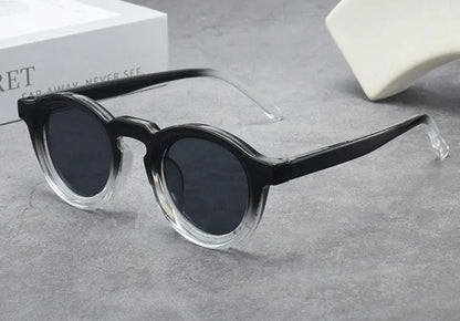 Retro round small frame sunglasses with black frames and dark lenses