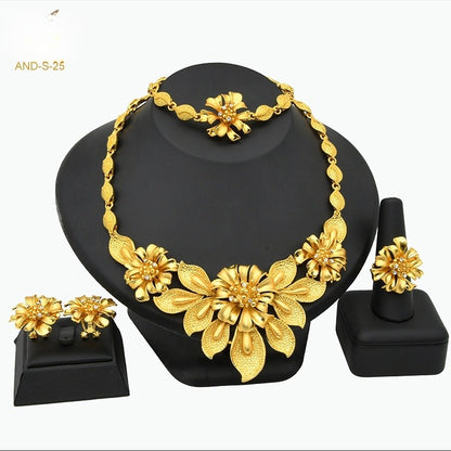 Gold floral jewelry set on a black stand with 'AND-S-25' text.