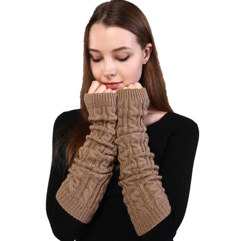 Woman wearing brown knitted arm warmers on a white background