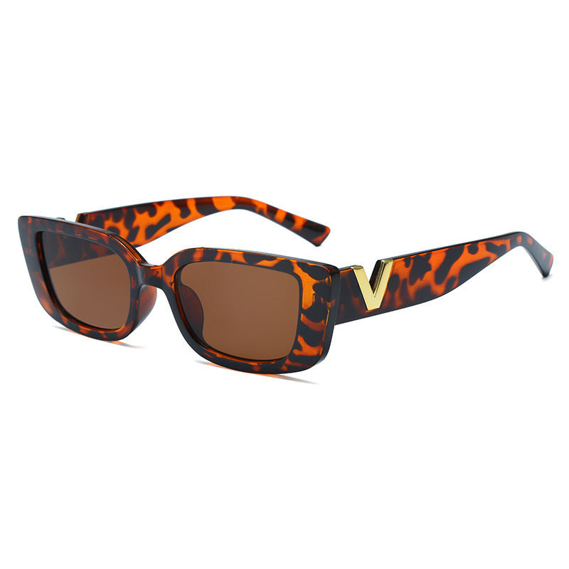 Sunglasses with leopard print frame and brown lenses on a white background