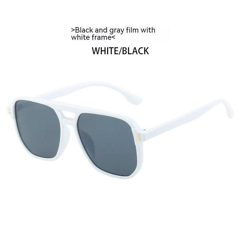 Sunglasses with black and gray lenses and white frame on a white background