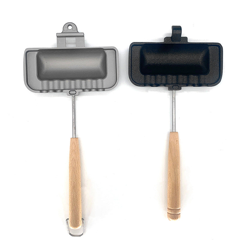 Two small frying pans with wooden handles on a white background