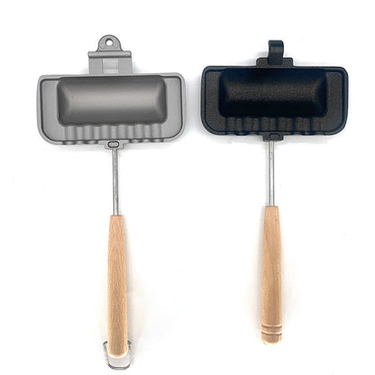 Two small frying pans with wooden handles on a white background