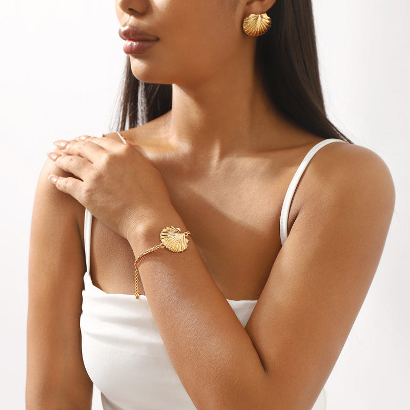 Gold-tone pearl bracelet with seashell charm and delicate bead links