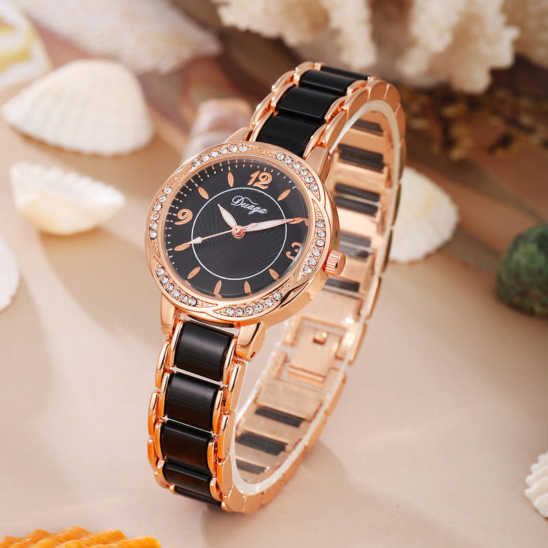 Rose gold round quartz wristwatch with dark dial and black link bracelet