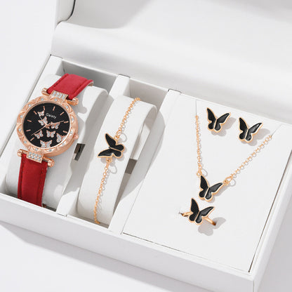 Jewelry set with a watch, bracelet, and necklace featuring butterfly designs in a white box.