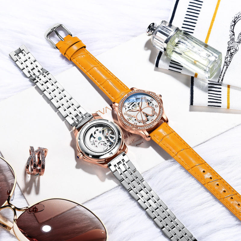 Set of two women’s watches: orange leather & silver metal bracelets, jeweled butterfly dials