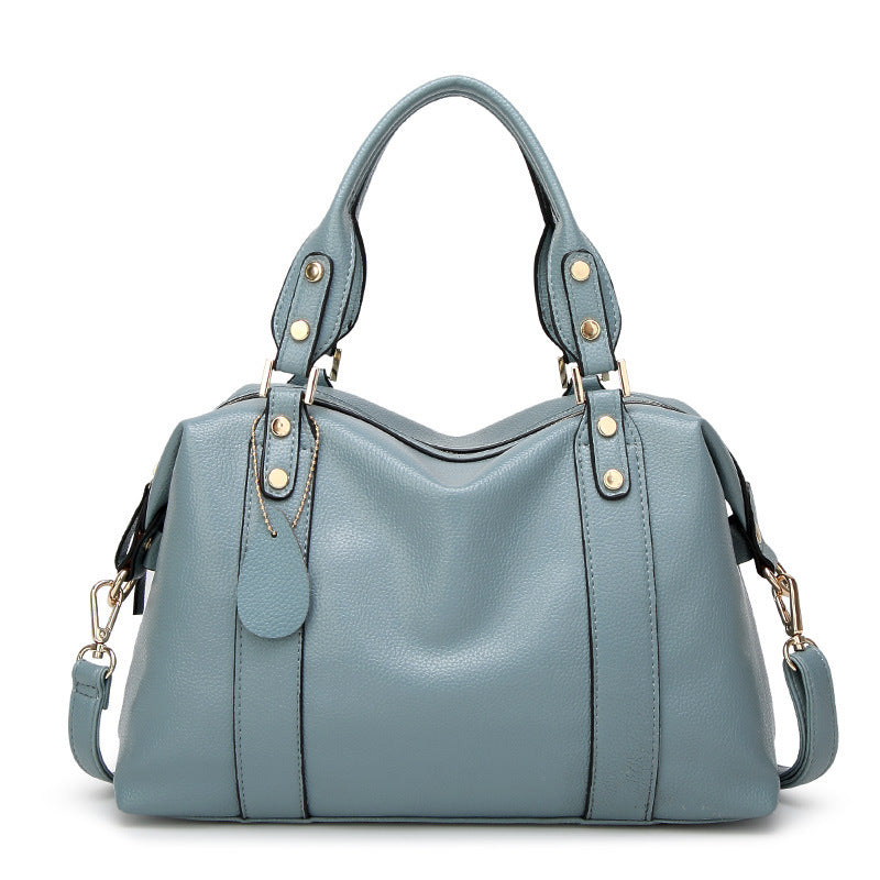 Blue handbag with gold accents on a white background