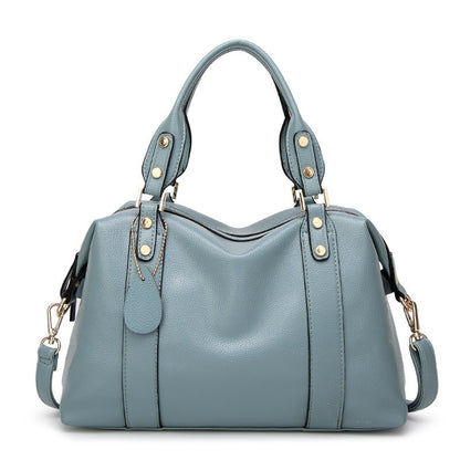 Blue handbag with gold accents on a white background