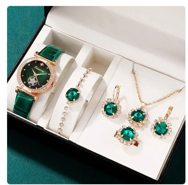 Jewelry set with green gemstones including a watch, bracelet, and earrings in a box.