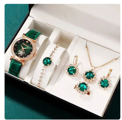 Jewelry set with green gemstones including a watch, bracelet, and earrings in a box.