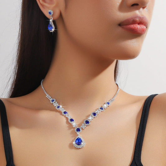 Bridal jewelry set with blue crystal drop necklace, teardrop pendant, and earrings