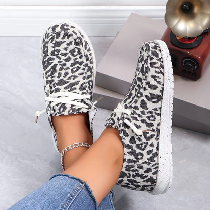 Leopard-print flat knit round-toe lace-up shoes on feet with white laces