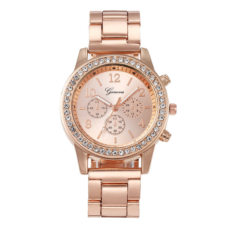 Rose gold quartz wristwatch with rhinestone bezel and light dial on metal link bracelet